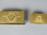 two gold - plated business cards with a picture of a man and woman on them
