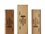 three wooden boxes with different types of wine in them