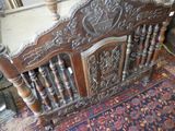 a bed that has a wooden headboard on it