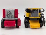 two toy tractors that are sitting next to each other