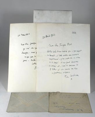 an open book sitting on top of a white table next to a piece of paper