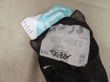 a mesh bag filled with items sitting on a couch
