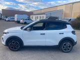 a white suv parked in a parking lot next to a building