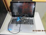 a laptop computer sitting on top of a white table