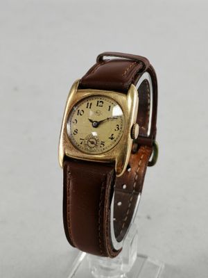 a close up of a wrist watch on a clear stand