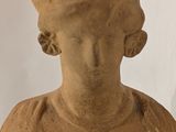 a statue of a woman with a hat on her head