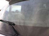 windshield of a car with a dog sitting in the passenger seat