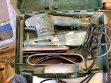 a green box with tools inside of it on a table