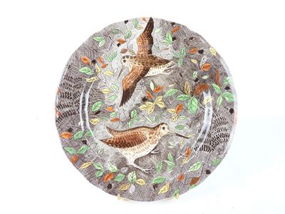 deux oiseaux posés sur une assiette garnie de feuilles