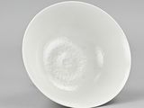 underside view of a white bowl on a gray surface