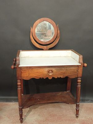 an old wooden table with a mirror on top of it