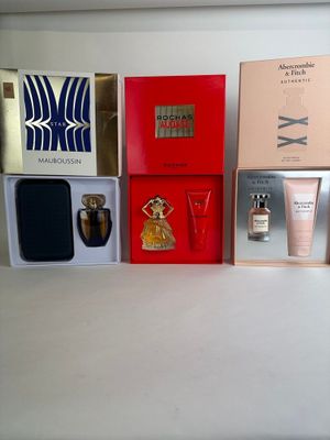 many different types of perfumes in boxes on a table