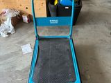 a blue hand truck that is sitting in a garage