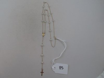 a rosary and a cross hanging on a wall