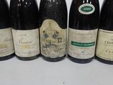 six bottles of wine are lined up on a table