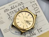 an image of a gold watch sitting on top of a piece of paper