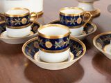 four cups and a saucer on a table