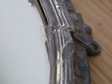 a close up of a mirror on a wooden table