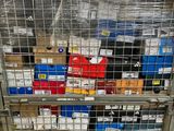 a metal cart with many boxes on it in a warehouse