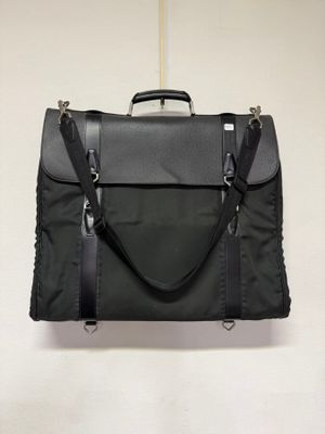 a black bag hanging on the wall with a handle