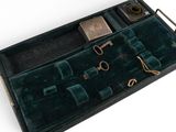 a black case with a key and other items in it