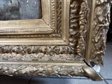 a gold frame with a picture of a man on it