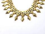 a gold necklace on a white background