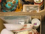 a box full of dishes and cups on the floor