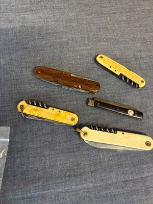 several different types of knives are laying out on a table