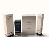 three boxes of perfume sitting next to each other on a white surface