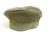 a green hat that is sitting on a white surface