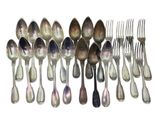 a lot of spoons and forks on a white surface
