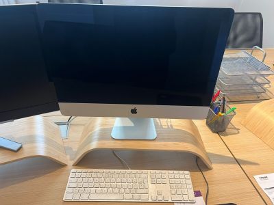 a desk with two monitors and a keyboard on it