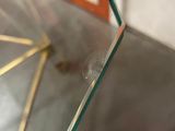 a close up of a glass table with a clock on it