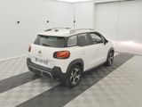 a small white car parked in a garage