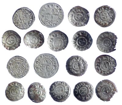 an image of a collection of silver coins on a white surface