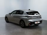 the rear end of a silver car is shown in a white room