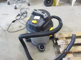 a wet dryer sitting on a pallet in a garage