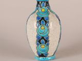 a blue and white vase sitting on a table