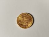 a close up of a gold coin on a white surface