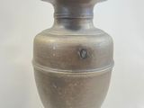 a vase that is sitting on a table with a white background