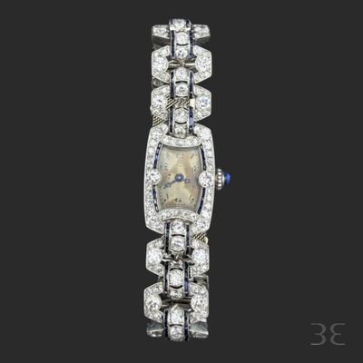 an art deco diamond and sapphire bracelet watch, by cartier
