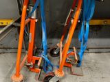 two orange and blue hand trucks that are on the floor