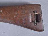 a close up of a wooden rifle with a metal handle