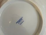 a close up of a white plate with a blue label on it