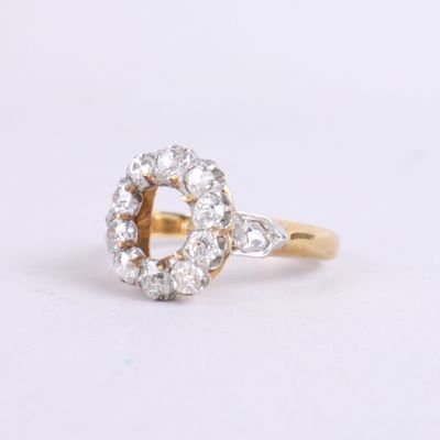 a close up of a diamond ring on a white surface