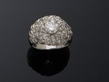a diamond clusterer ring on a black surface