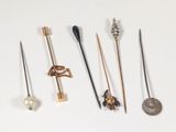 many different types of pins and needles on a white surface