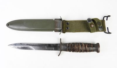 two knives with a green sheath and a brown sheath on a white background