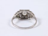an image of a diamond and white gold ring on a white surface